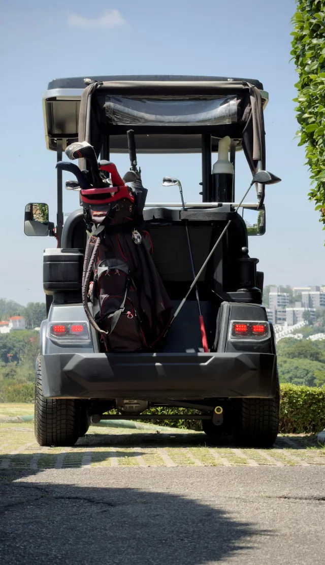 Golf cart with a bag of clubs on the back