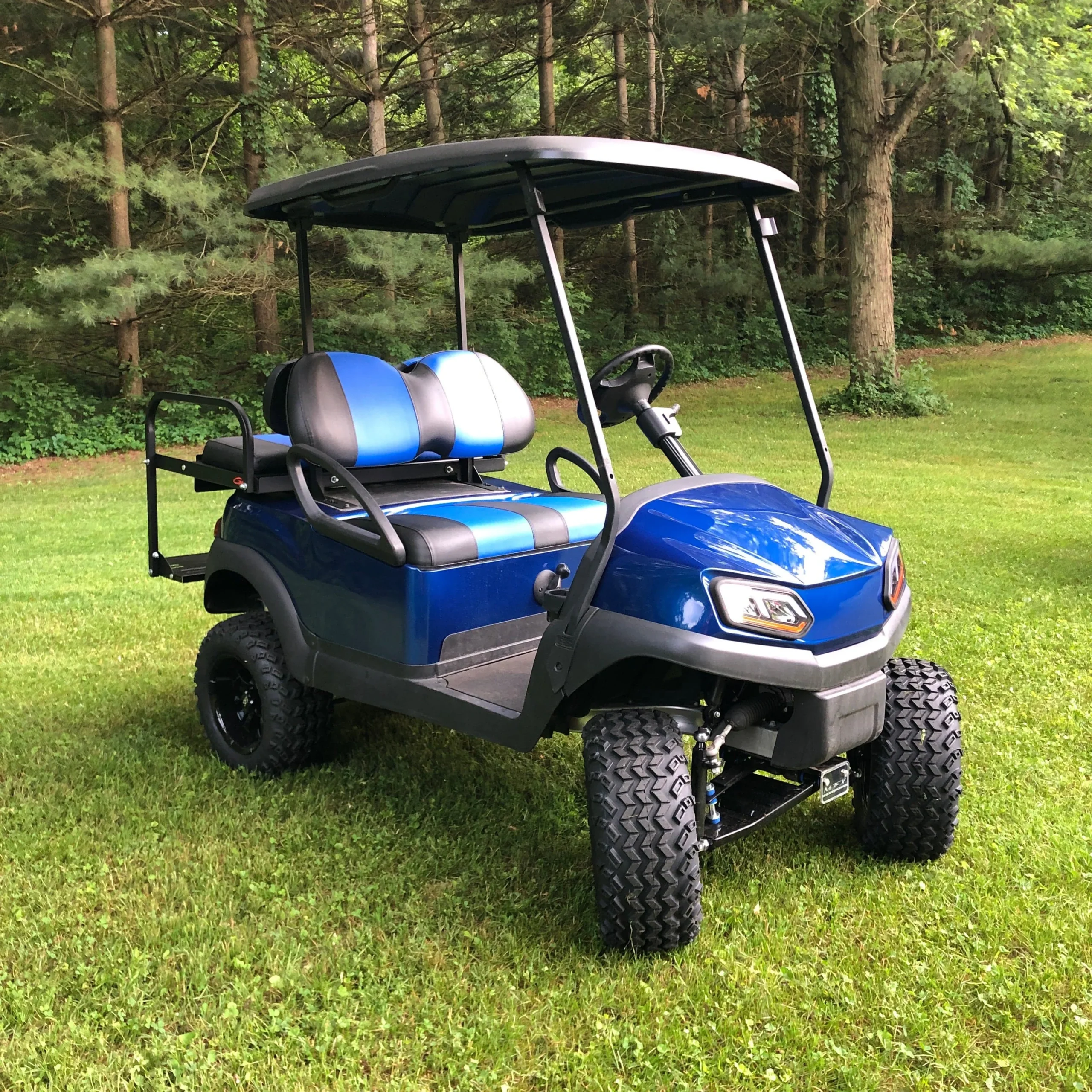 Lifted golf cart used to illustrate rear seat spring installation on an E-Z-GO