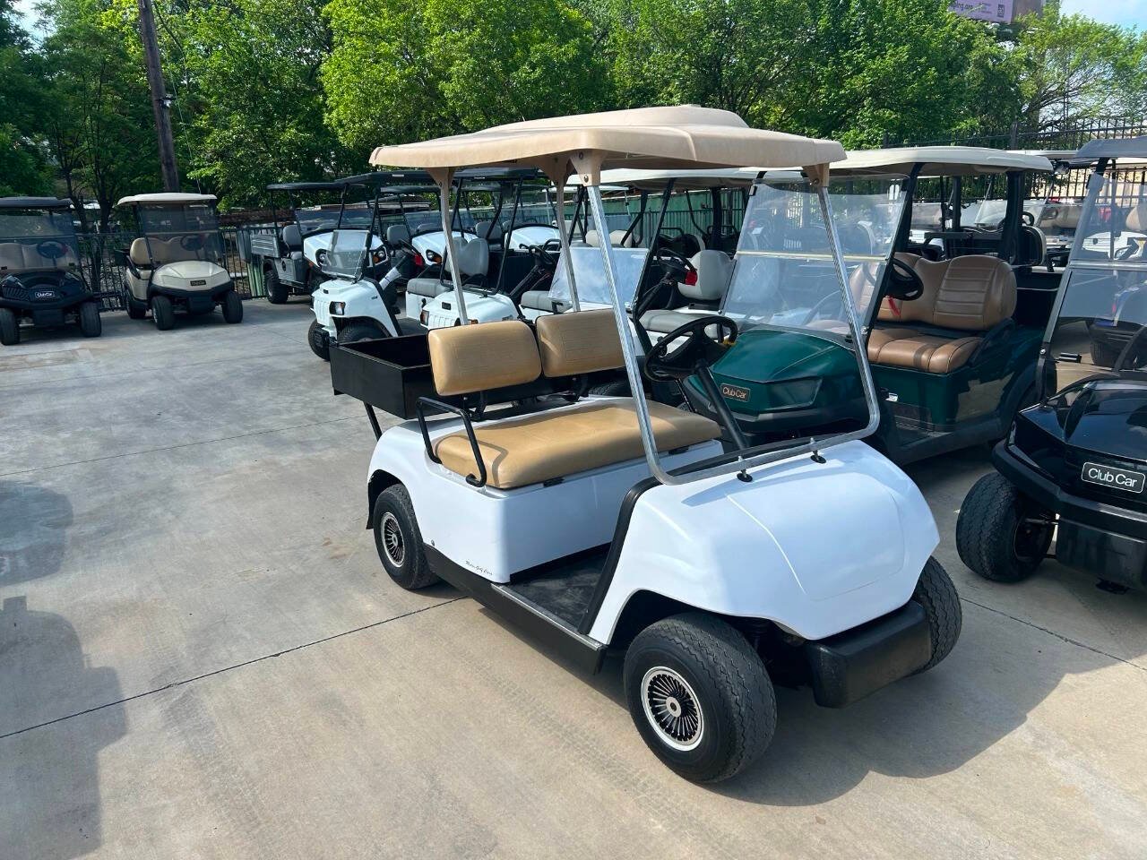 Used golf carts for sale on a dealer lot for new vs used golf cart comparison