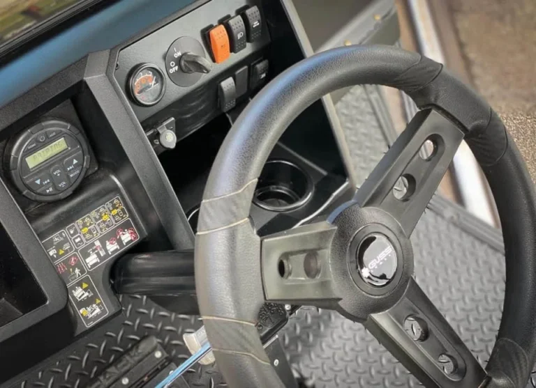 Cushman Hauler steering wheel and dash close-up illustrating a Cushman golf cart hard to steer diagnosis