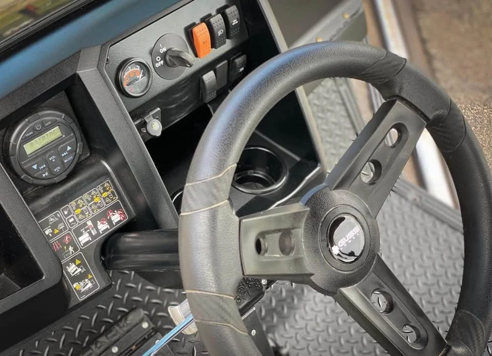 Cushman Hauler steering wheel and dash close-up illustrating a Cushman golf cart hard to steer diagnosis