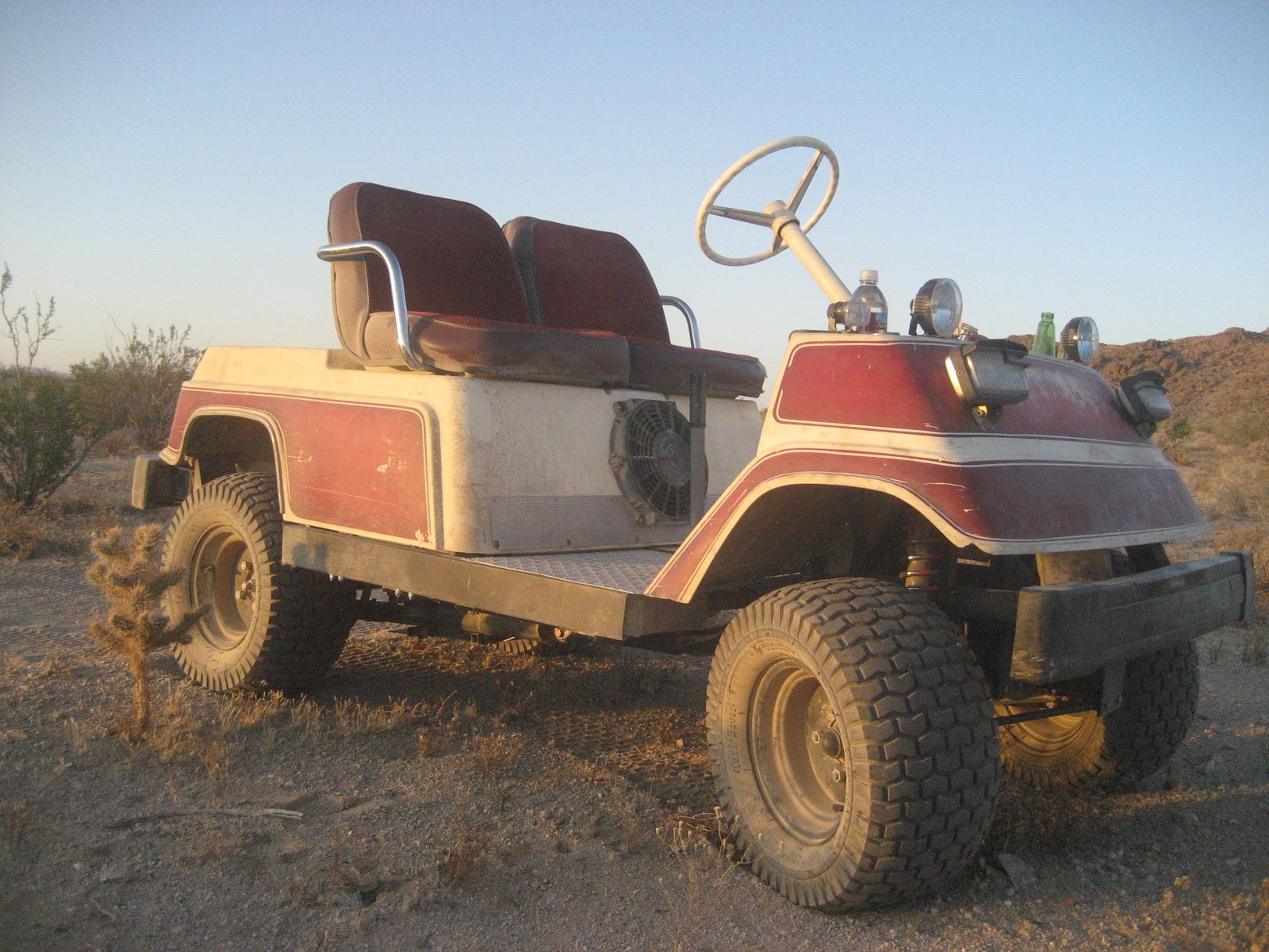 lifted off road all terrain golf cart with knobby tires