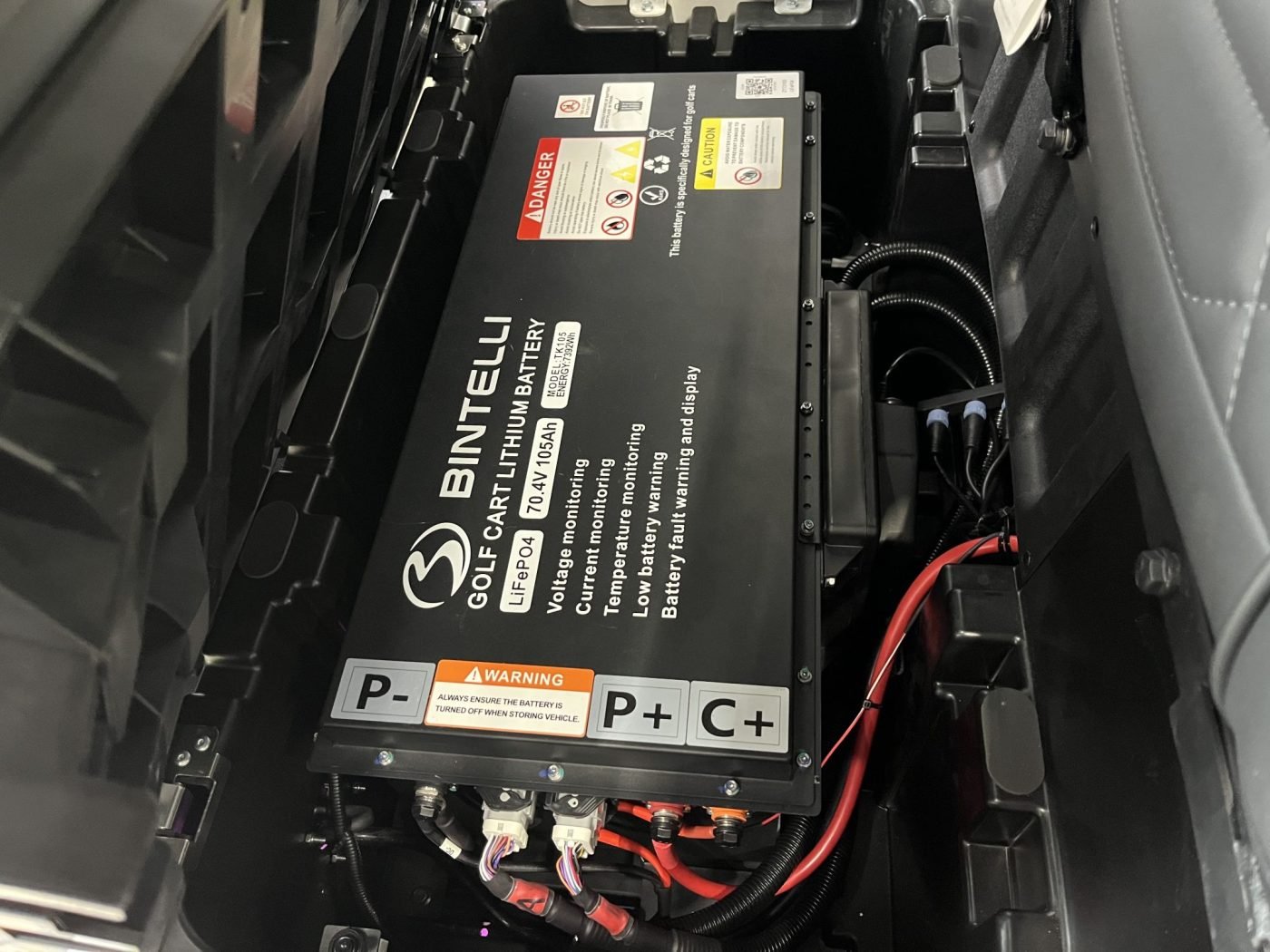 Golf cart lithium battery pack under the seat, relevant to diagnosing Bintelli golf cart lithium battery problems